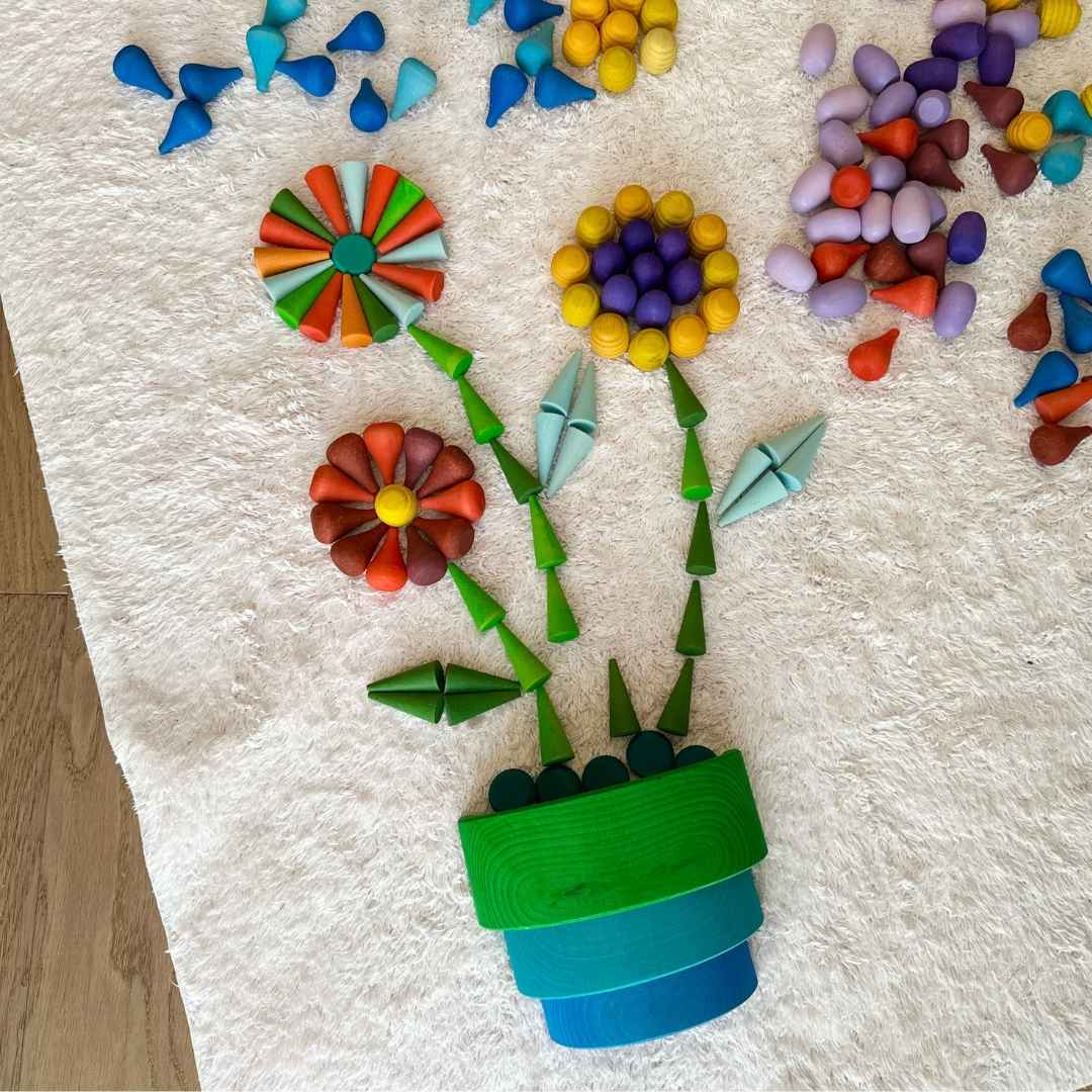 Bunte Holzteile als Blumen mit Blumentopf
